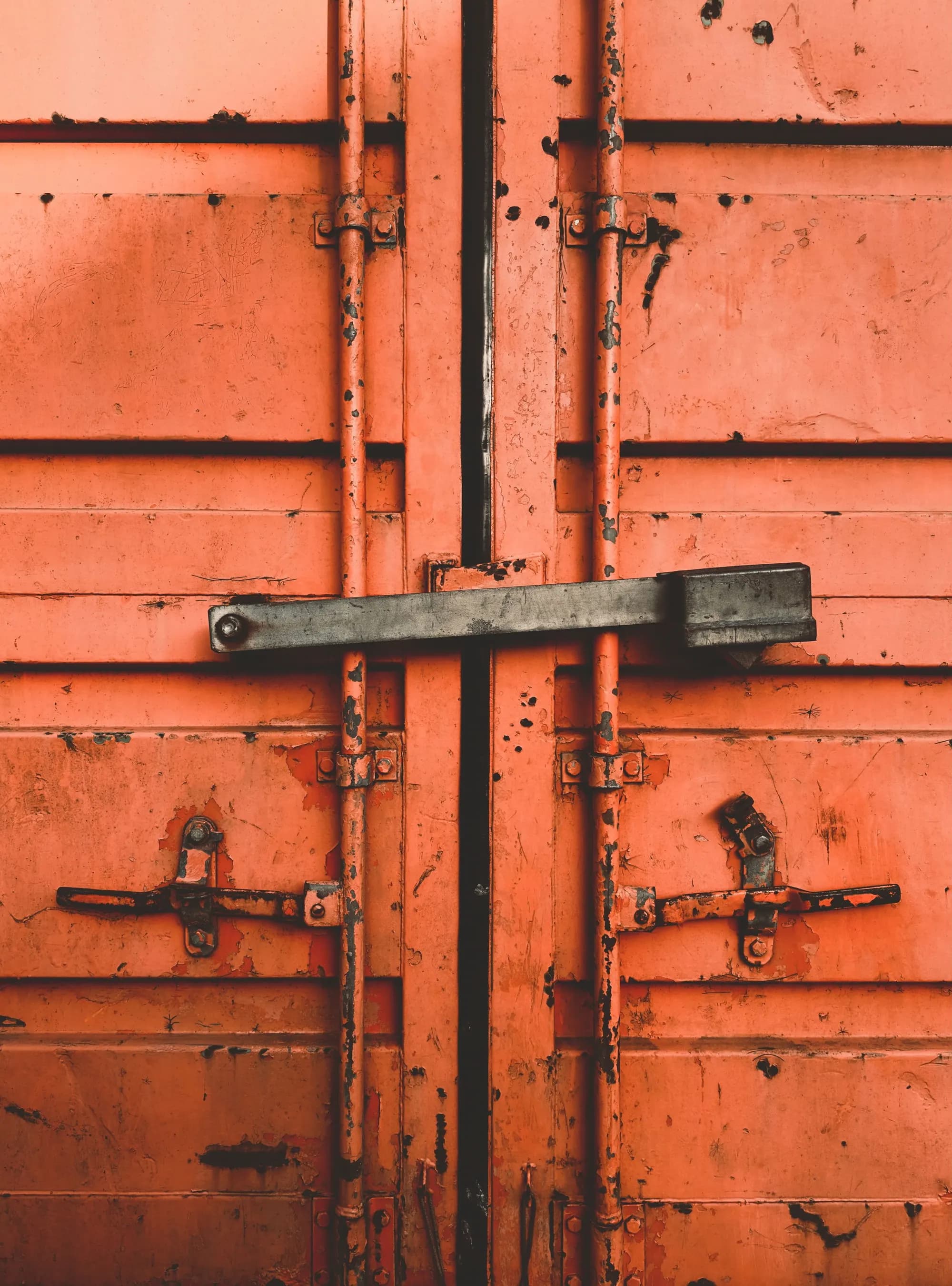 The locking bars of a shipping container door, up close
